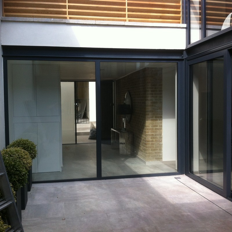 Floor-to-ceiling sliding doors opening to courtyard in Beaconsfield